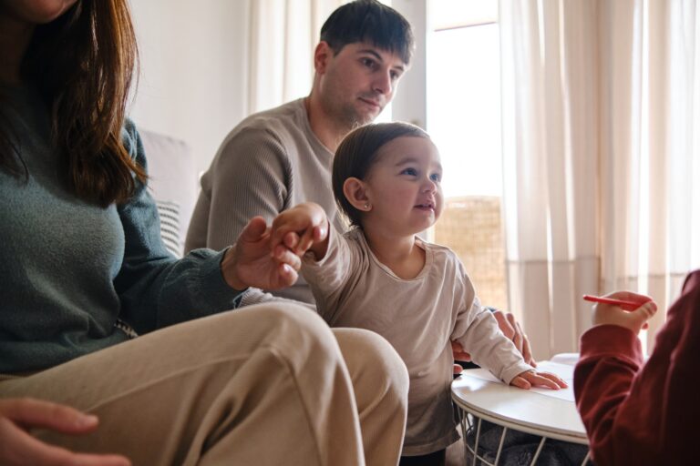 Parents enjoying time with their kids while relaxing at home.